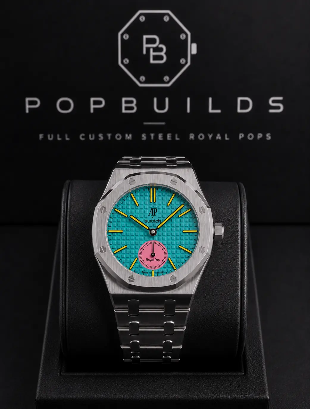 Otg Roz full mod watch with a turquoise aftermarket dial and pink sub-dial in a stainless-steel case